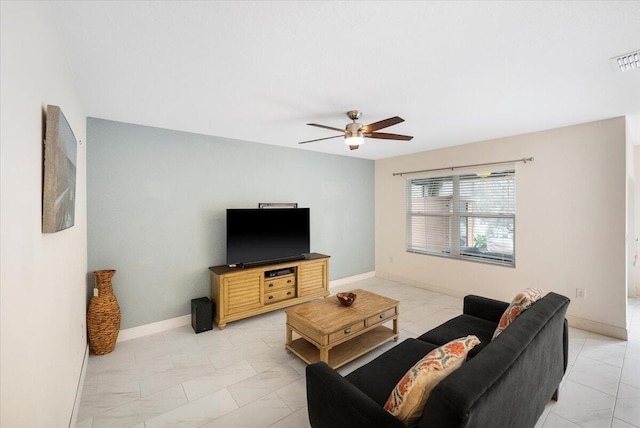 living area with marble finish floor, visible vents, baseboards, and ceiling fan