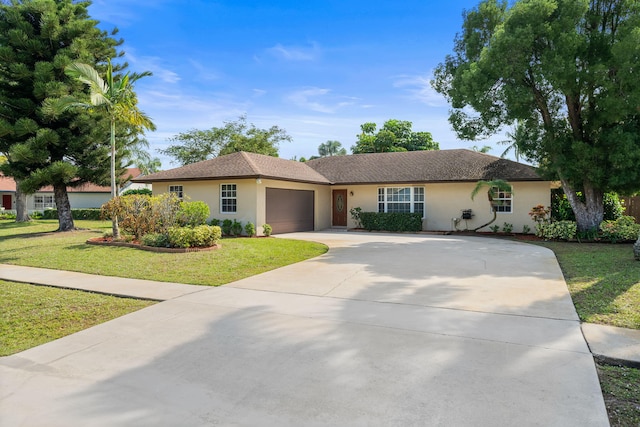 single story home featuring a garage and a front yard