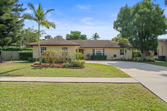 ranch-style house featuring central AC unit and a front lawn