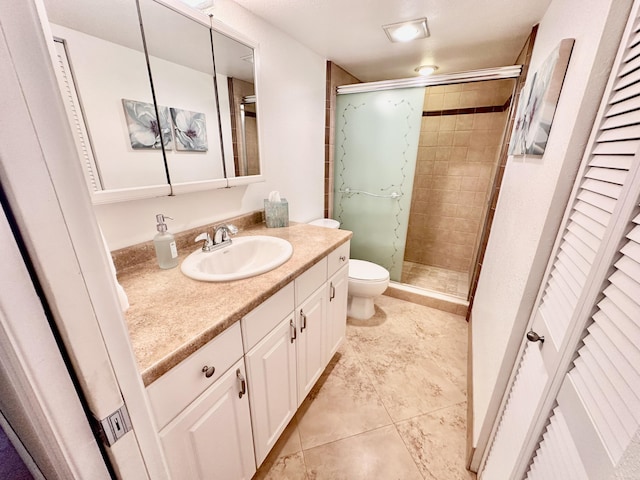 full bathroom featuring toilet, a stall shower, a closet, and vanity