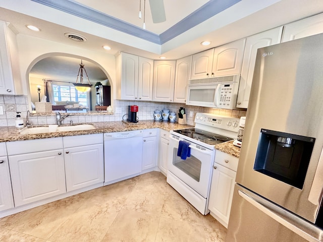 kitchen featuring decorative light fixtures, sink, white appliances, tasteful backsplash, and white cabinets