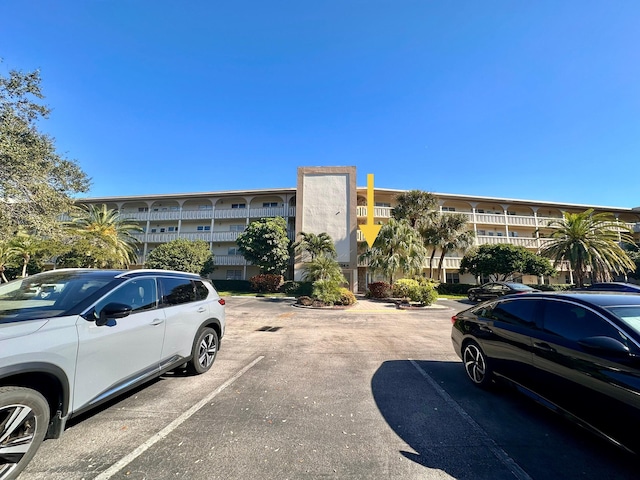 view of property featuring uncovered parking