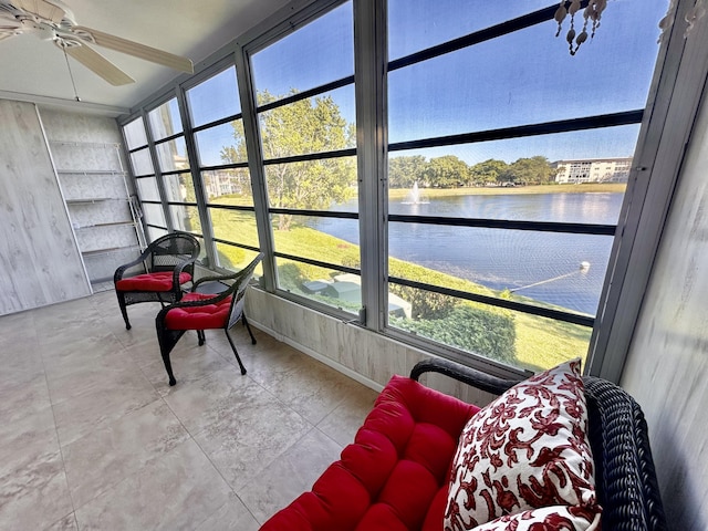 sunroom with a water view and ceiling fan