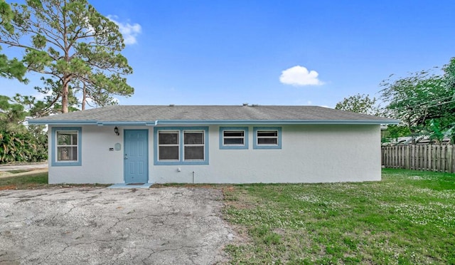 rear view of house featuring a yard