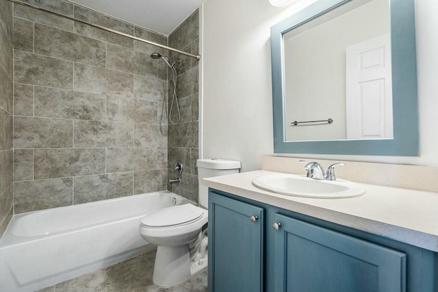 full bathroom with tile patterned flooring, vanity, toilet, and tiled shower / bath