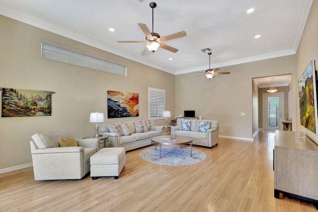 living area with crown molding, a healthy amount of sunlight, light wood finished floors, and baseboards