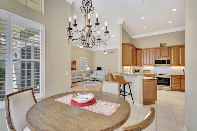 dining area featuring a wealth of natural light, ceiling fan, and light tile patterned flooring