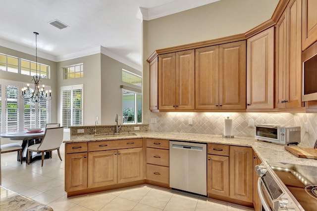 kitchen featuring hanging light fixtures, stainless steel appliances, light stone countertops, a chandelier, and a sink