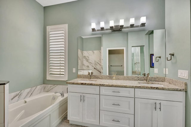 full bathroom with double vanity, a garden tub, and a sink