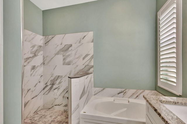 full bathroom featuring a bath, vanity, and tiled shower