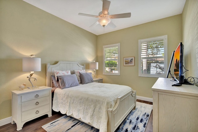 bedroom featuring baseboards, ceiling fan, and wood finished floors