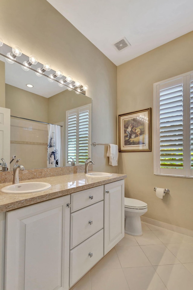 full bath featuring double vanity, toilet, visible vents, and a sink