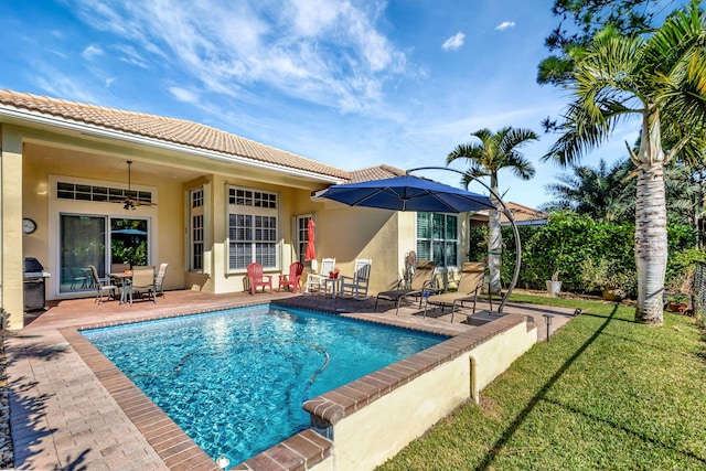 pool featuring a lawn and a patio