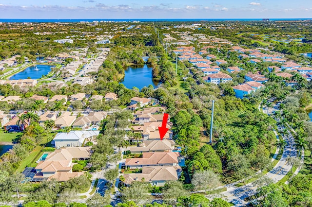 drone / aerial view featuring a water view and a residential view