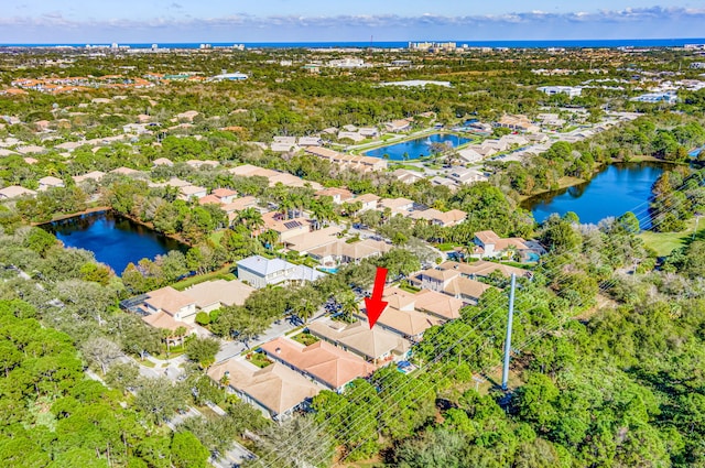 drone / aerial view featuring a residential view and a water view