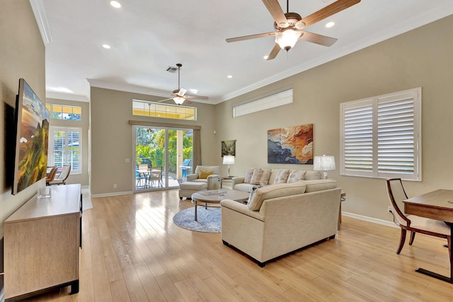 living room featuring ornamental molding, baseboards, and light wood-type flooring