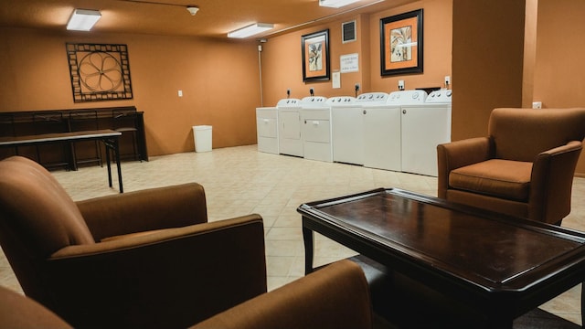 interior space featuring light tile patterned floors, washing machine and dryer, and visible vents