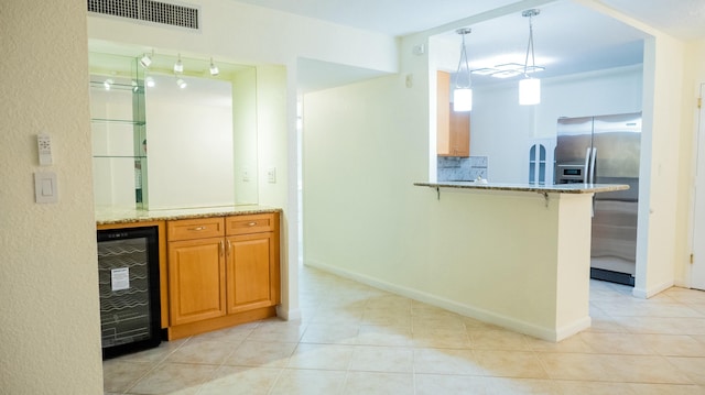 bar featuring wine cooler, visible vents, hanging light fixtures, stainless steel fridge with ice dispenser, and tasteful backsplash