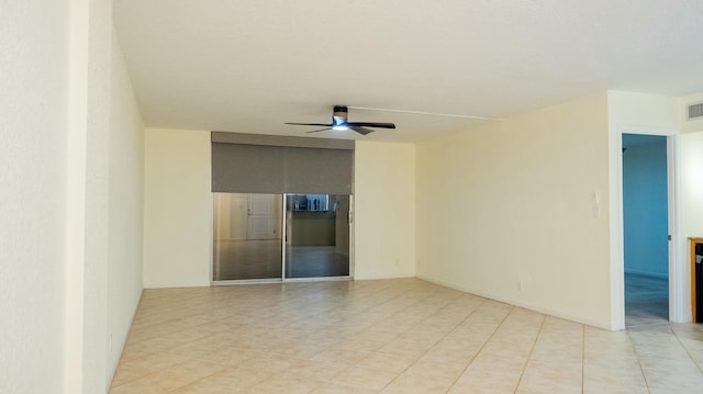 unfurnished room with visible vents and ceiling fan