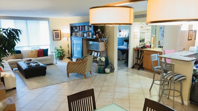 living room featuring light tile patterned floors and visible vents