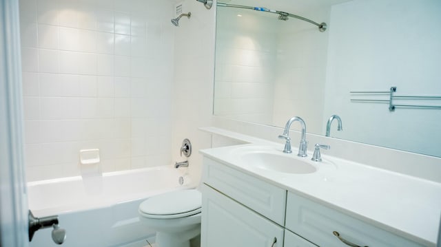 bathroom with shower / washtub combination, vanity, and toilet