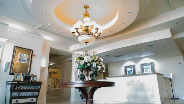 reception featuring visible vents and a notable chandelier