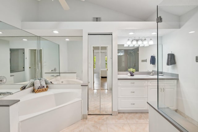 full bathroom featuring visible vents, lofted ceiling, tile patterned floors, vanity, and a bath