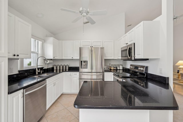 kitchen with light tile patterned floors, white cabinetry, appliances with stainless steel finishes, and a sink