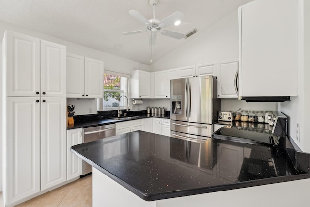 kitchen with a peninsula, a sink, visible vents, white cabinetry, and appliances with stainless steel finishes