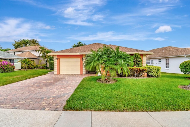 single story home with a garage, a front lawn, and decorative driveway