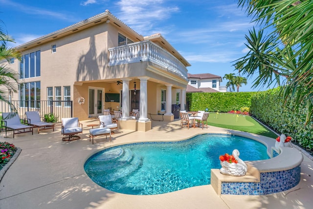 view of pool with french doors, a patio area, fence, and ceiling fan