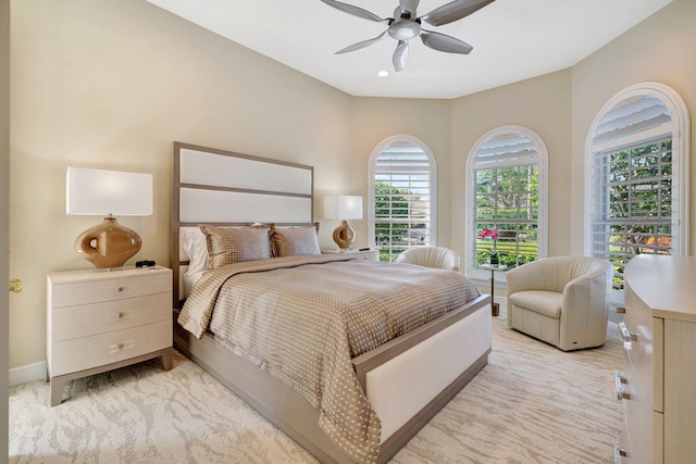 bedroom with ceiling fan and baseboards