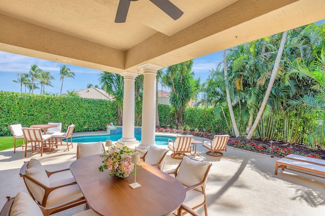 view of patio featuring a ceiling fan, outdoor dining space, and a fenced in pool