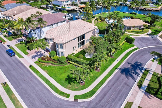 birds eye view of property with a water view and a residential view