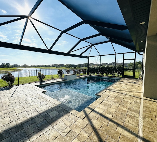 pool featuring glass enclosure, a patio, and a water view