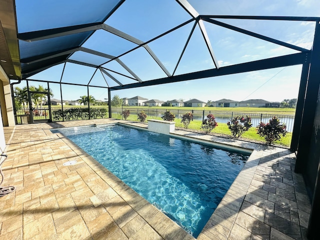 view of pool with a patio, a fenced in pool, fence, a water view, and a lanai