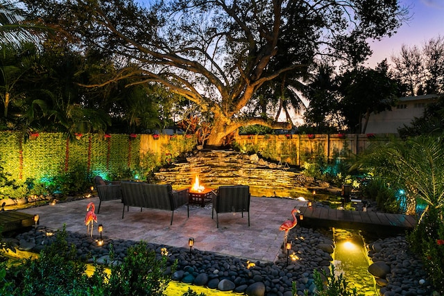 view of patio / terrace featuring an outdoor fire pit and a fenced backyard