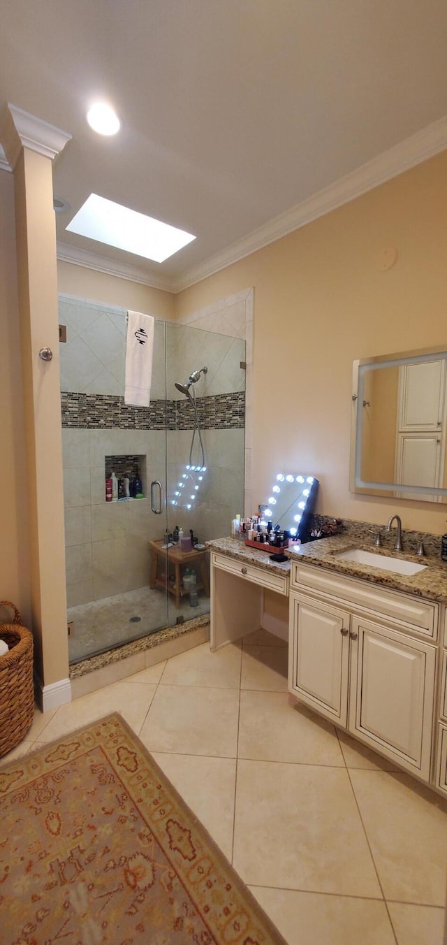 bathroom with crown molding, vanity, a shower stall, and tile patterned floors