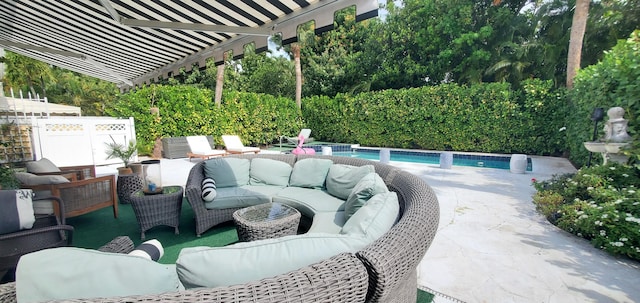 view of patio with fence, an outdoor living space, and a fenced in pool