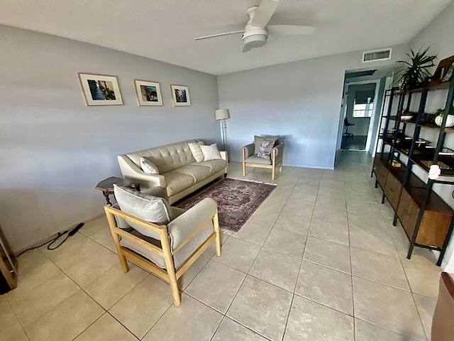 living room with light tile patterned floors, ceiling fan, and visible vents