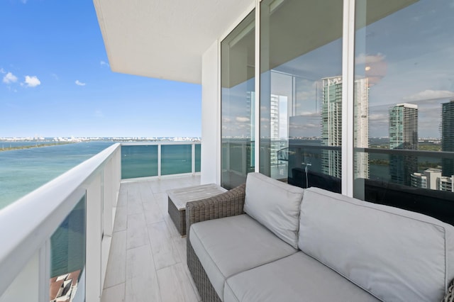 balcony with a water view and a city view