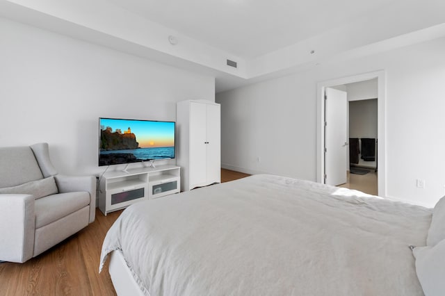 bedroom featuring visible vents and wood finished floors