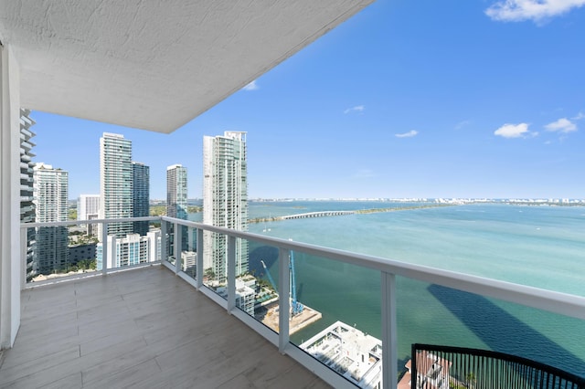 balcony with a water view and a city view