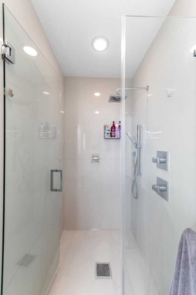 full bathroom featuring a stall shower and tile patterned floors