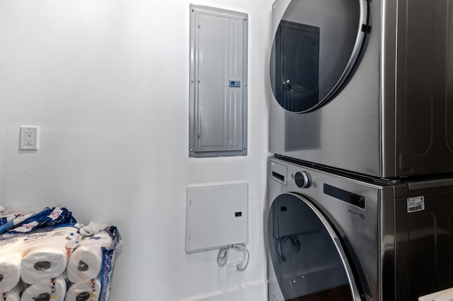 laundry area featuring stacked washer and dryer, electric panel, and laundry area