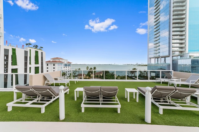 view of community featuring a yard and a water view