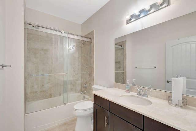 bathroom featuring vanity, toilet, and bath / shower combo with glass door