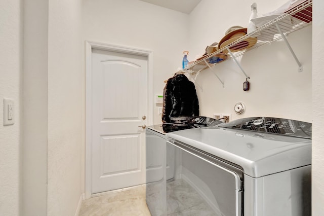 washroom featuring laundry area and separate washer and dryer