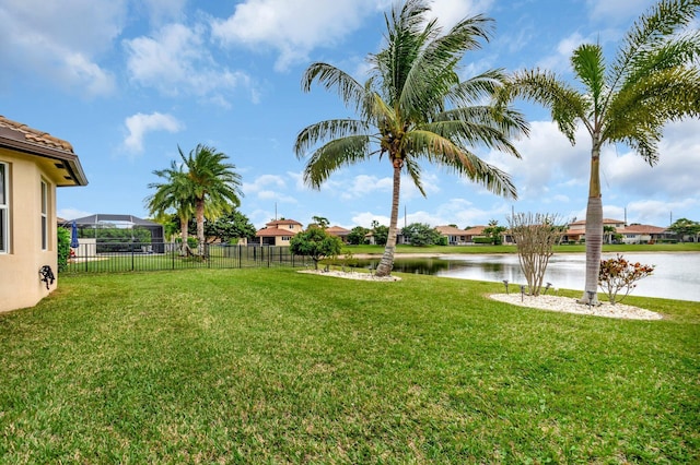 view of yard featuring a water view and fence