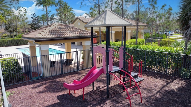 community play area with fence and a community pool